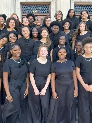 Sheldon All-Stars Chorus posing and smiling on steps to a building